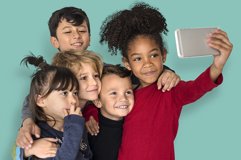 Children are taking a group selfie.